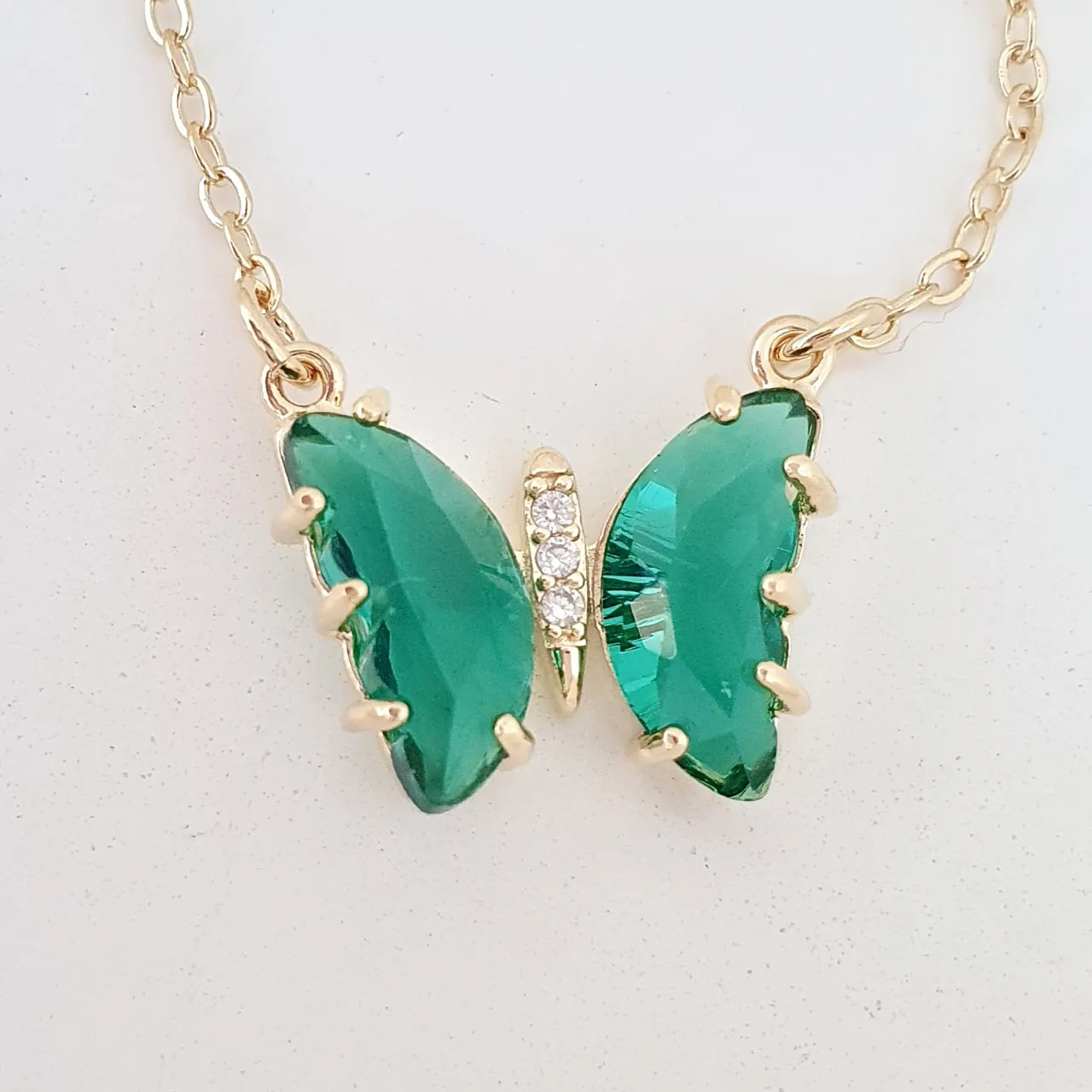 Pulseira dupla com borboleta de zircônia verde