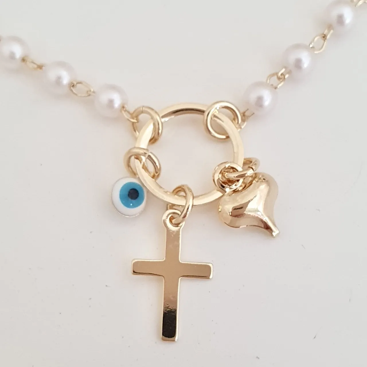 Pulseira pérola olho grego, cruz e coração