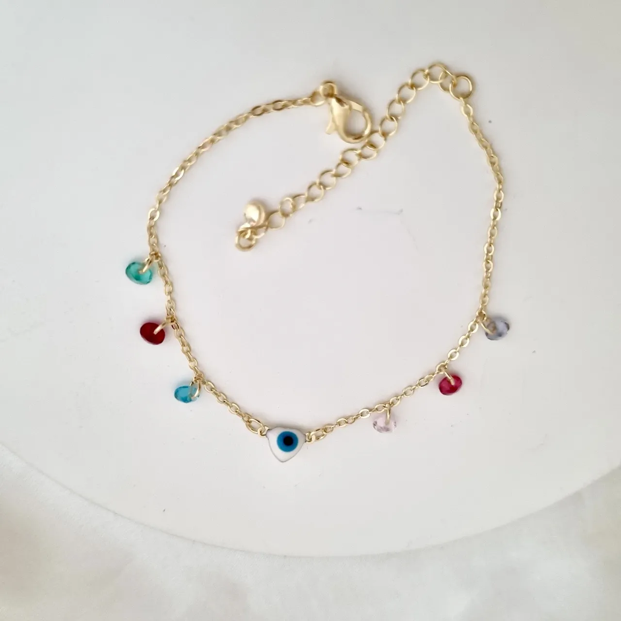 Pulseira olho grego em formato de coração e zircônias coloridas