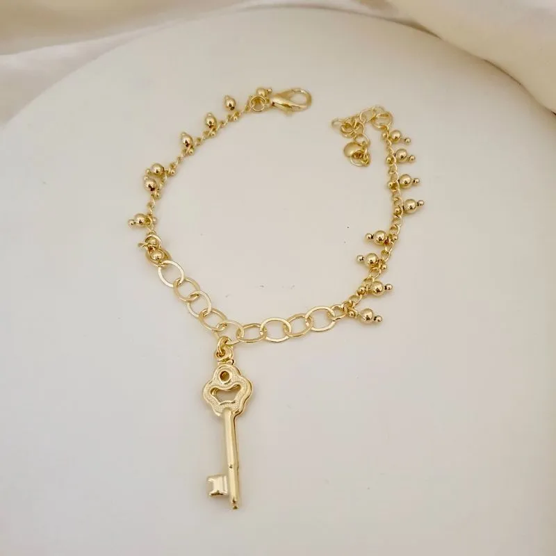 Pulseira pingente chave bolinhas